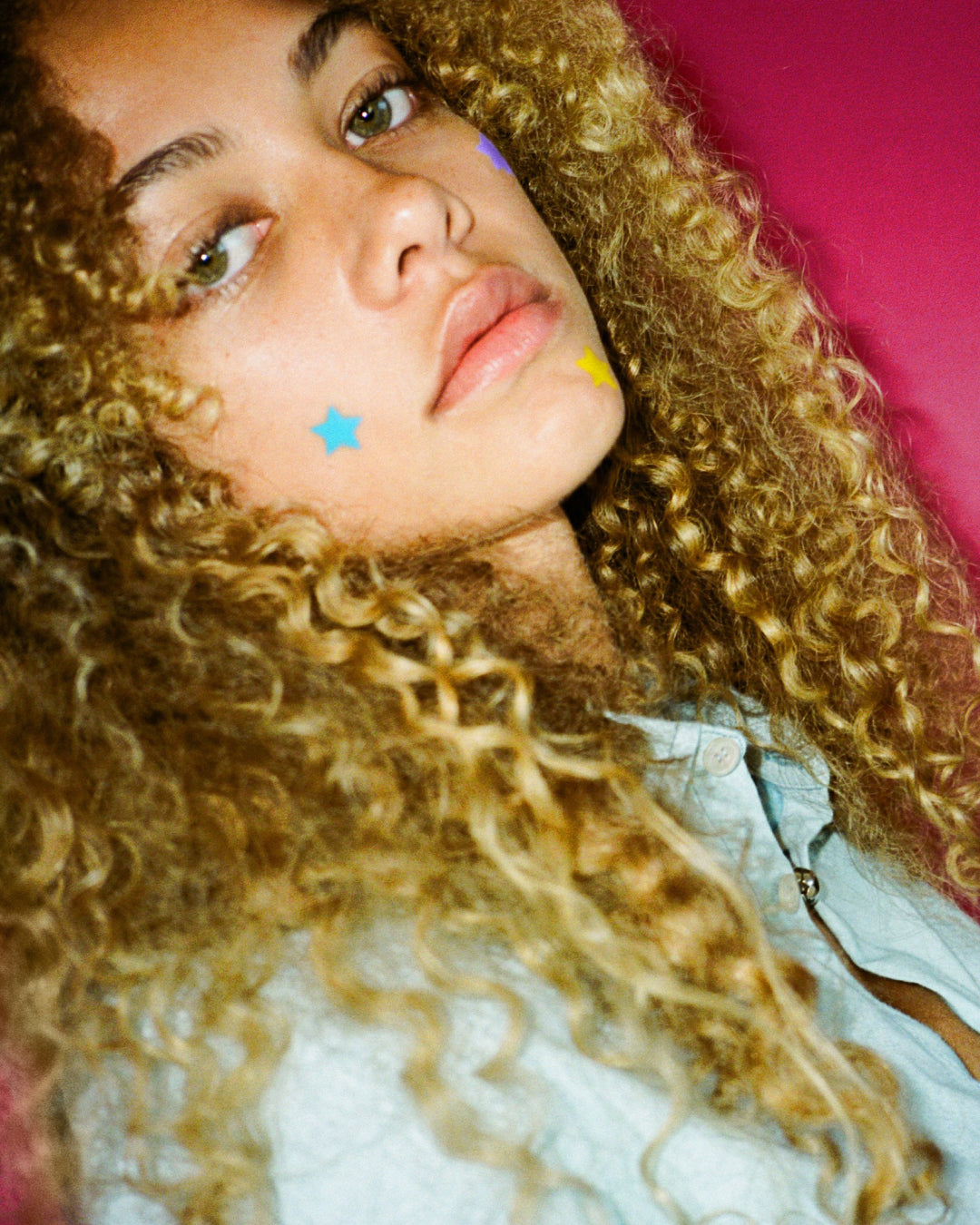 A person wearing Starface Hydro-Star® patches from the Super Star Bundle. Star-shaped patches for every spot.