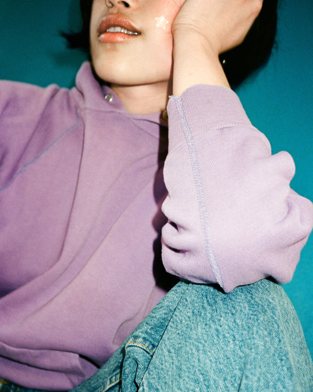 A person wearing invisible Starface Hydro-Star® Clear pimple patches. Star-shaped patches that shield each spot.