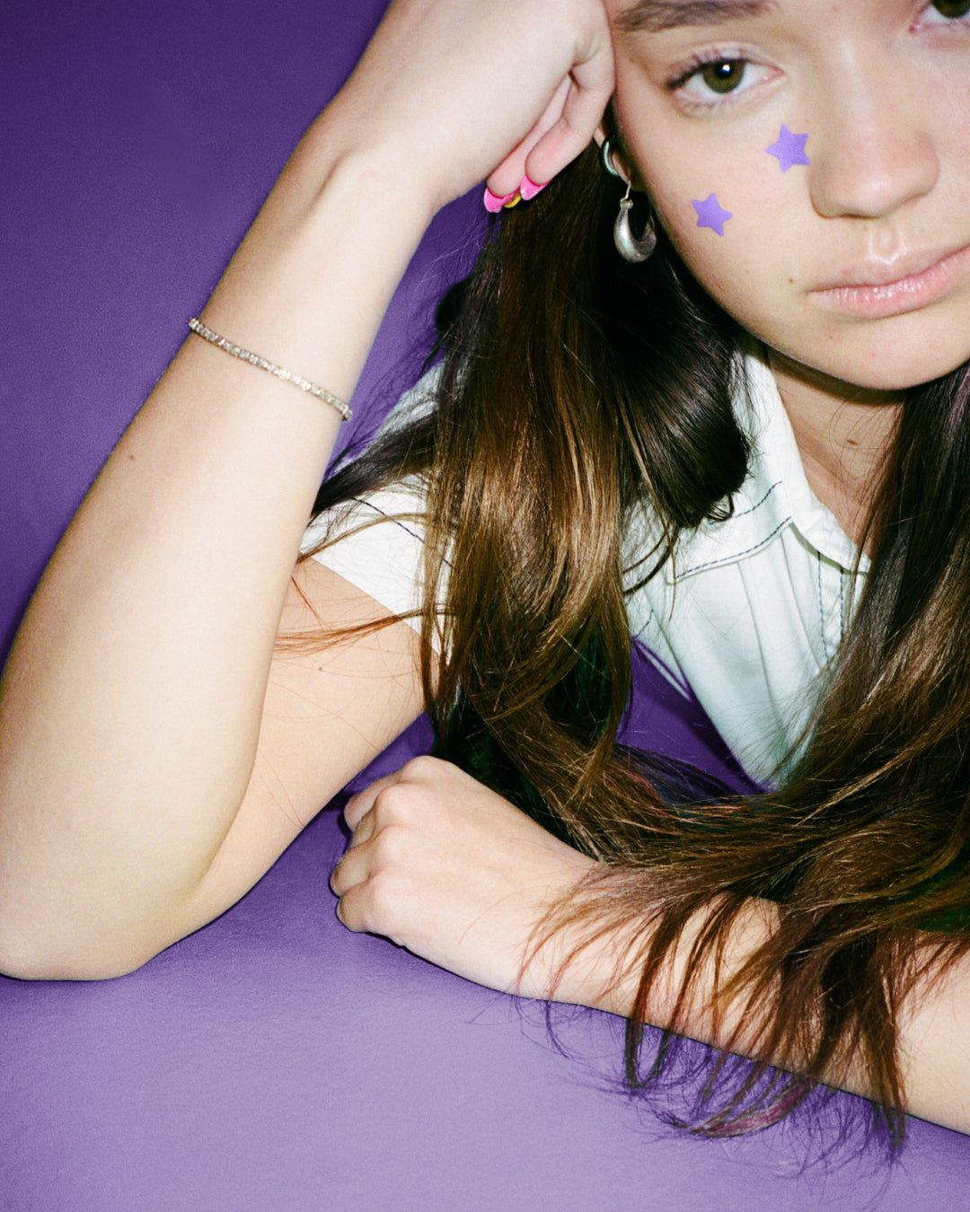 Lifestyle portrait of a person wearing Starface Hydro-Star® Recovery patches. Soothing stars for skin in recovery.