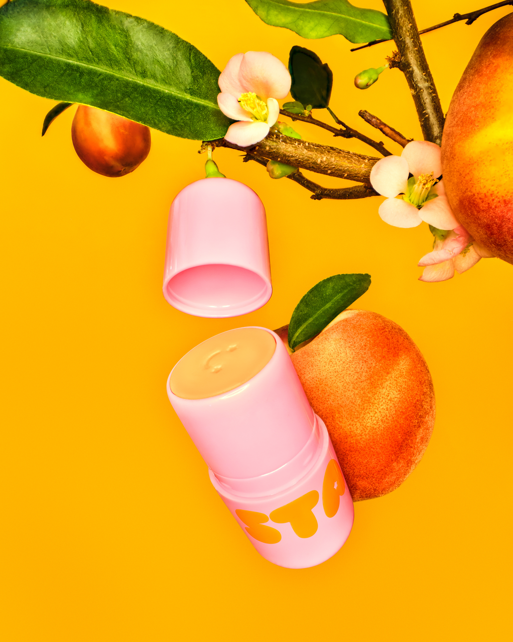 Starface Star Balm® Perfectly Peachy lip balm uncapped. Shea butter, cocoa butter and coconut oil hydrate dry lips.