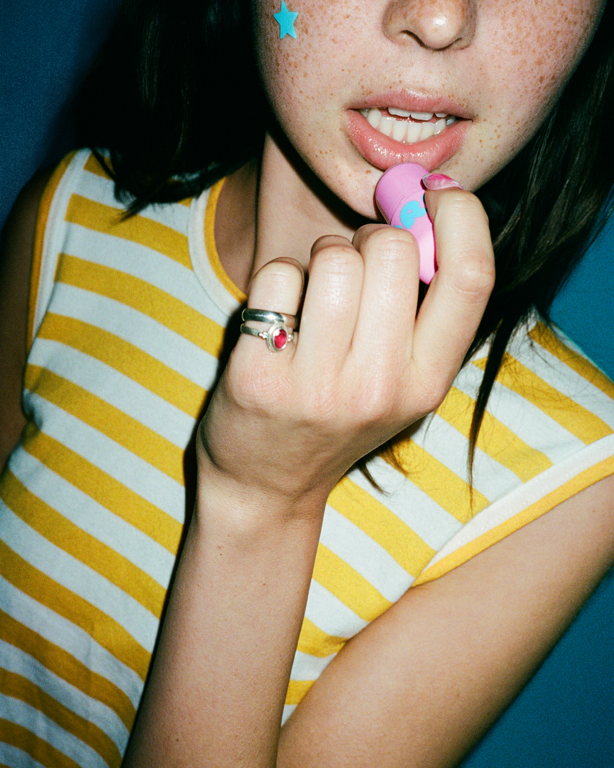 Lifestyle portrait of a person with Starface Star Balm® Bubblegum Bliss. A limited-edition bubblegum balm for daily wear.