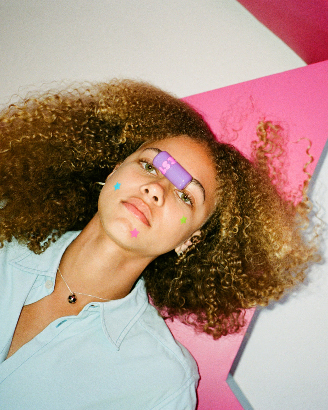 Lifestyle portrait of a person with Starface Star Balm® Dream Berry. A sweet berry lip balm for everyday wear.