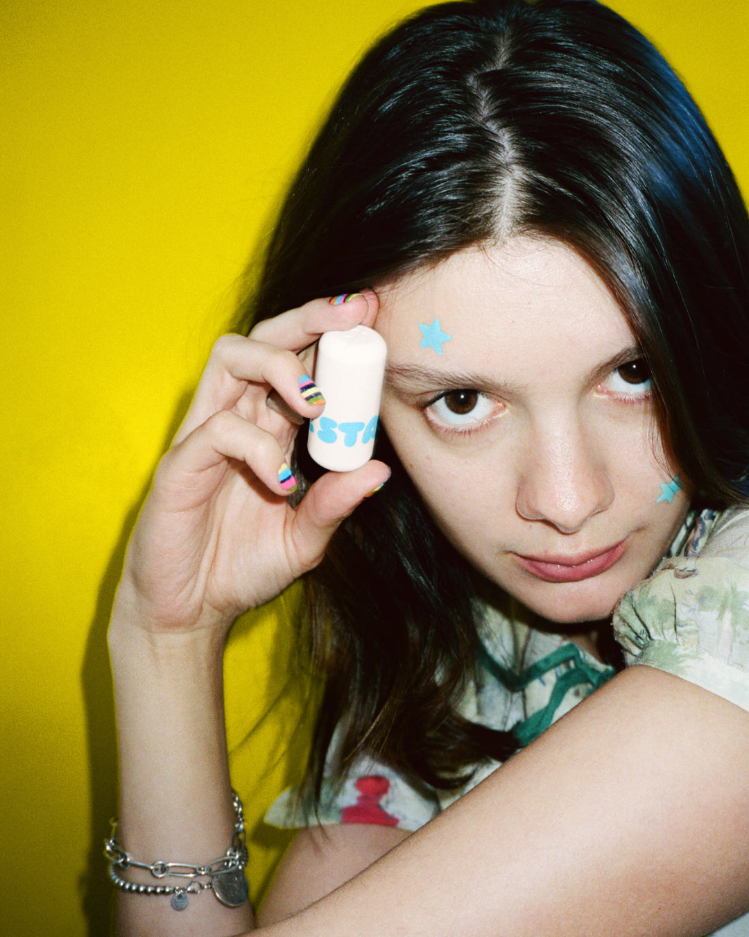 A person holds up Starface Star Balm® in Very Vanilla. This sweet vanilla lip balm leaves lips soft and hydrated.