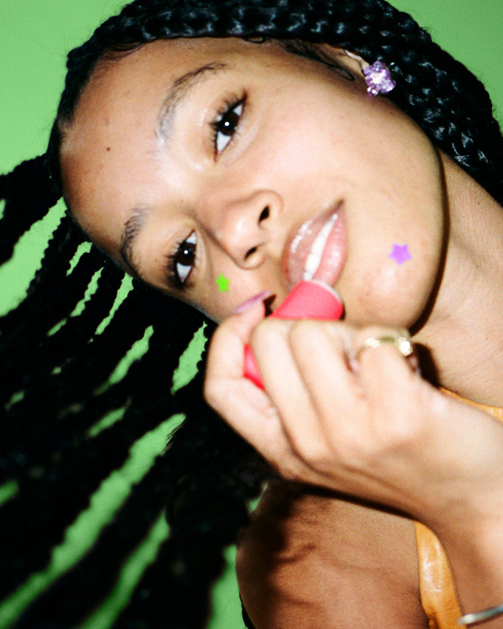 A person wears Starface Star Balm® in Watermelon Squeeze. This juicy lip balm leaves lips soft and hydrated.