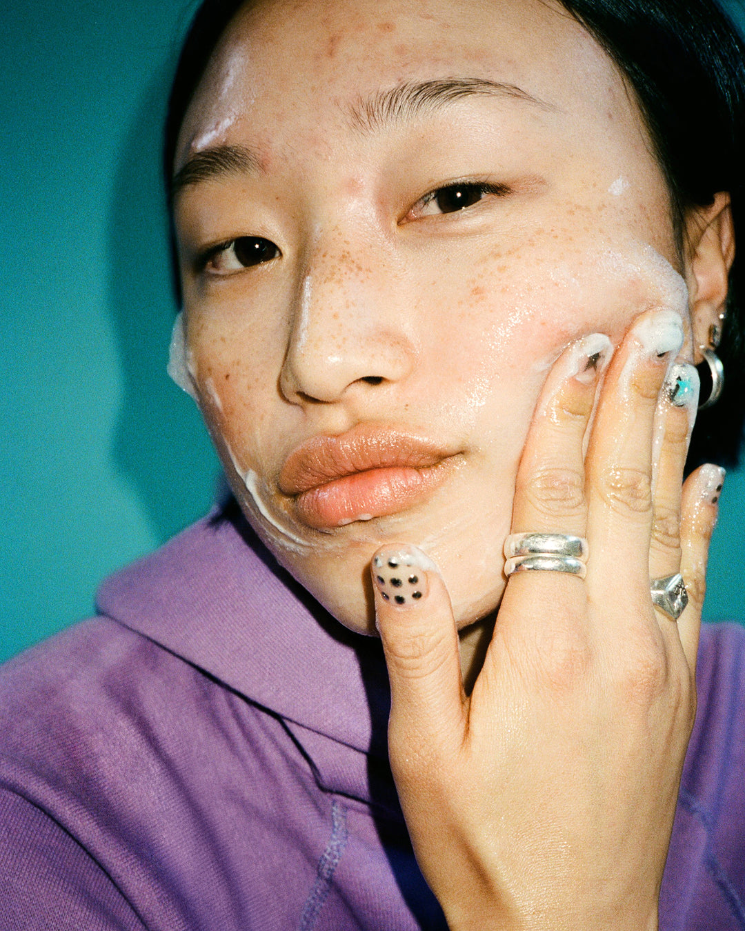 A person cleansing with Starface Star Wash® + Salicylic Acid face wash. Foaming gel that unclogs pores and reduces oil.